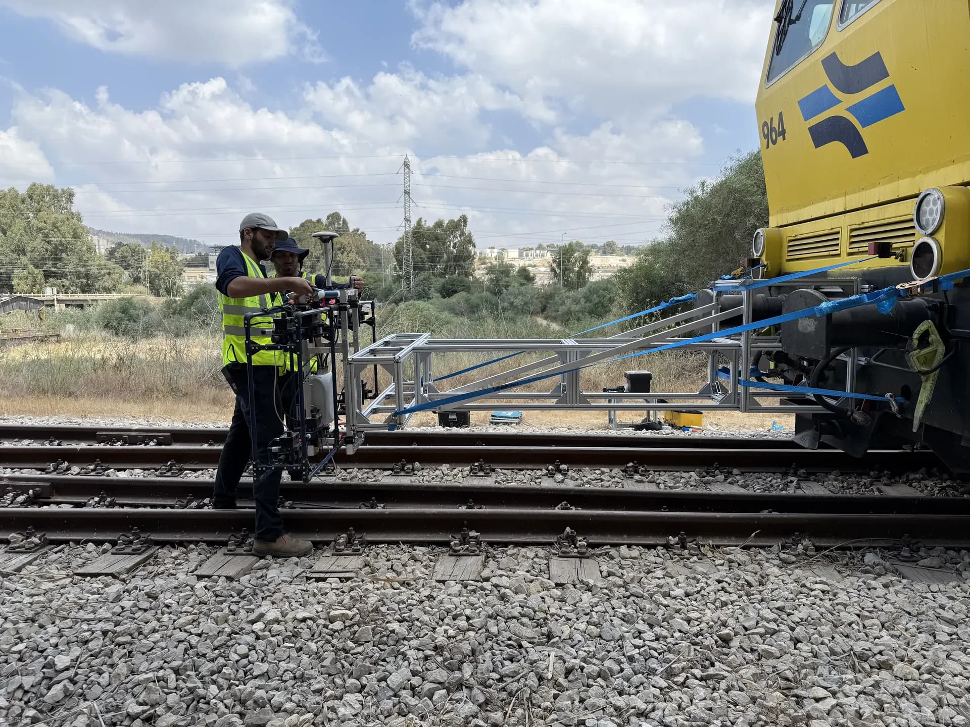 Exodigo field engineer scanning an active rail corridor at dusk